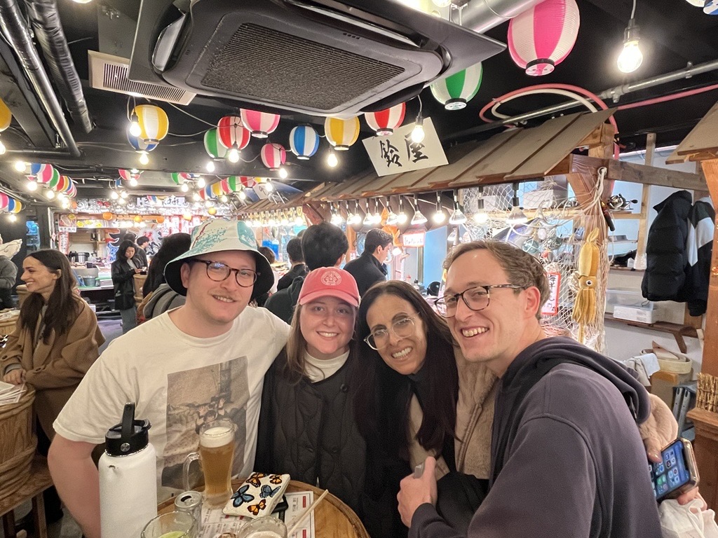 Sharon with family at a market in Japan